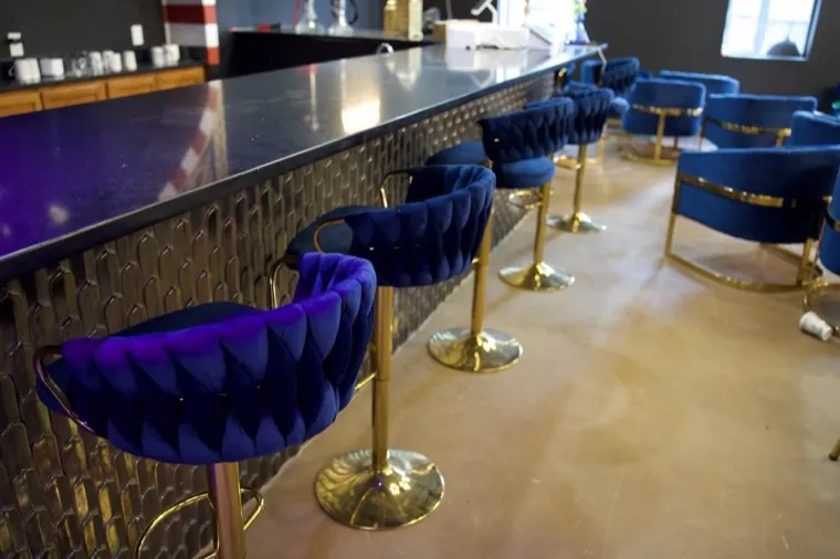 Bar counter with blue velvet stools