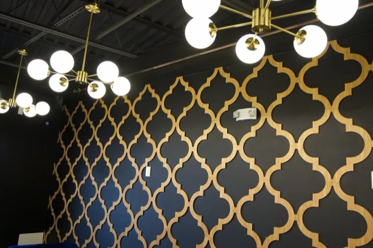 Velvet booths beneath a modern chandelier