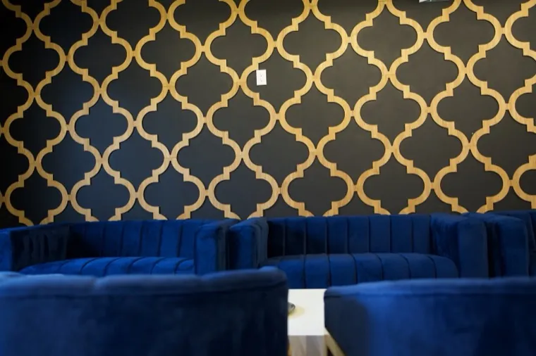 Navy booths and gold patterned wall