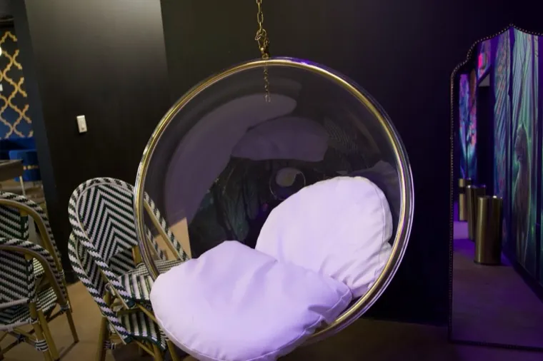 Hanging egg chair with soft pink cushions