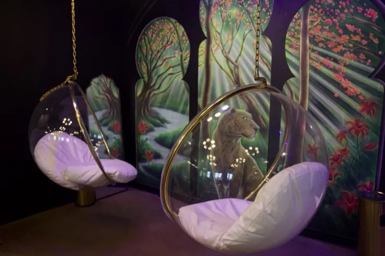 A seating nook framed by a glowing mural