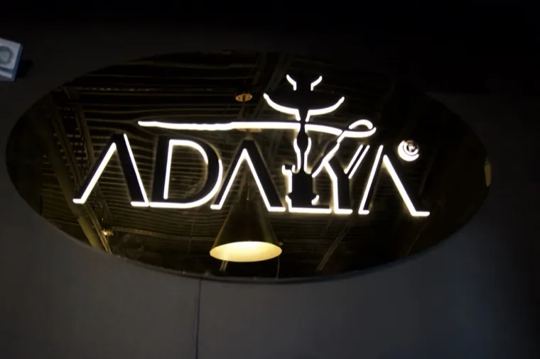 Neon sign glowing in the dark lounge