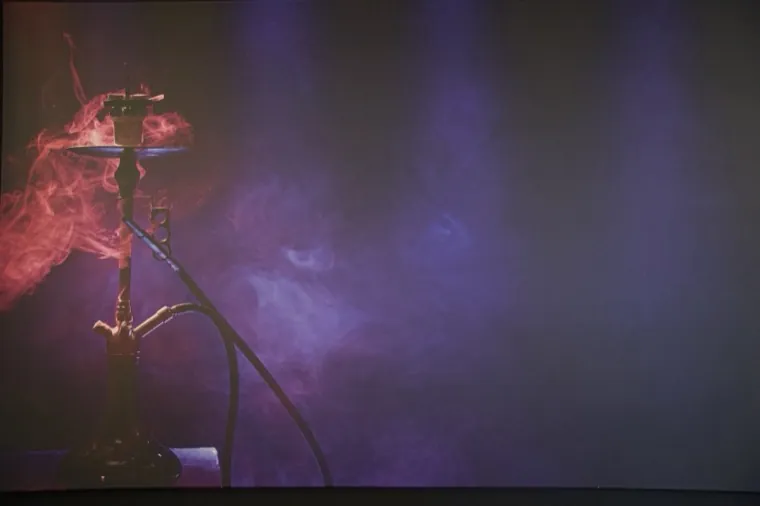 A hookah silhouette wreathed in colored smoke